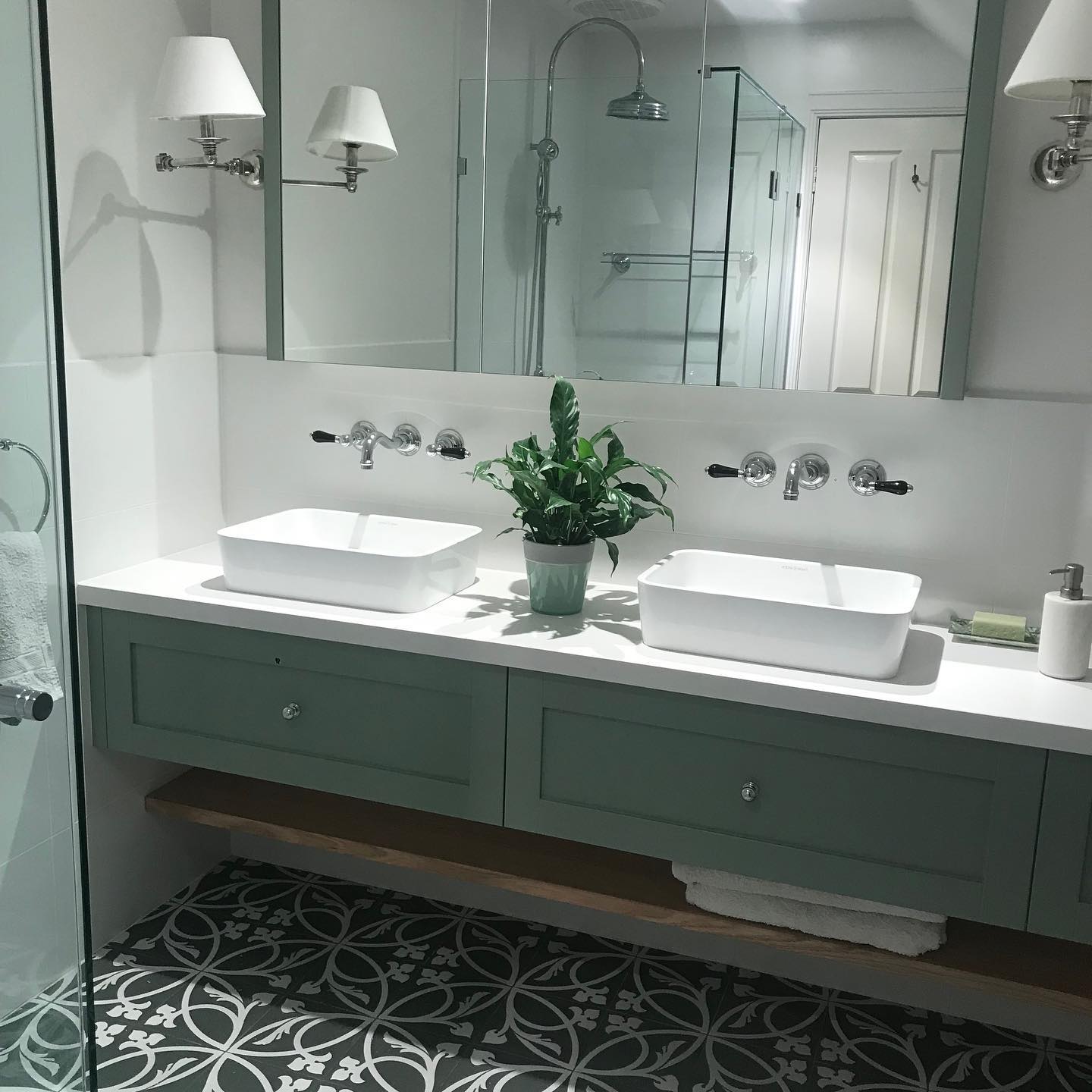 A recently completed bathroom renovation with Hampton style Vanity Unit.  Frame constructed, shaker style drawer fronts, timber storage shelf and stone bench top. A wonderful choice of colour, tiles and hardware complete the look and create this gorgeous, relaxing bathroom.